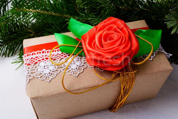 Christmas kraft paper wrapping present with golden ribbon and ro Stock photo © TasiPas