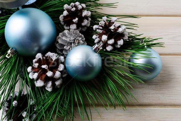 Christmas background with blue ornaments and decorated pine cone Stock photo © TasiPas