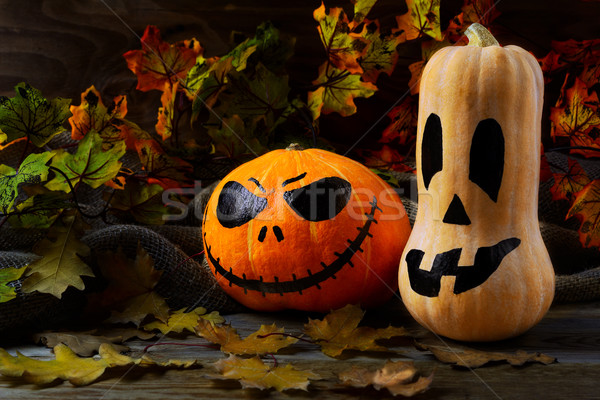 Halloween traditional jack-o-lantern and fall leaves Stock photo © TasiPas