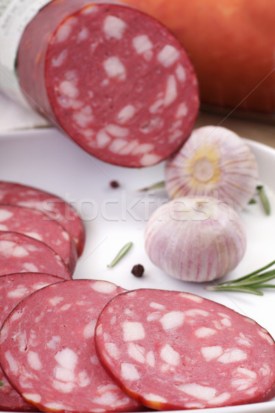 salami slicing next to rosemary and garlic Stock photo © Tatik22