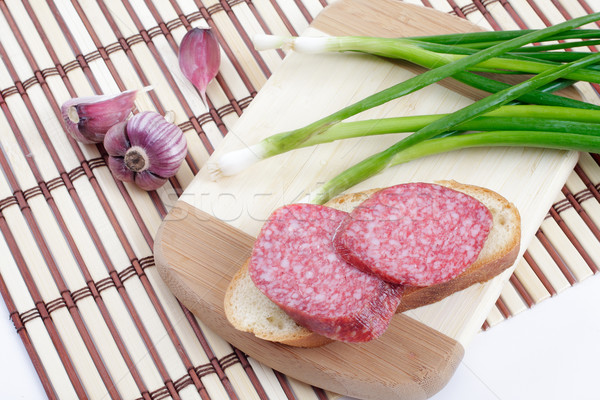 Sandwich with smoked sausage on the chopping board Stock photo © Tatik22