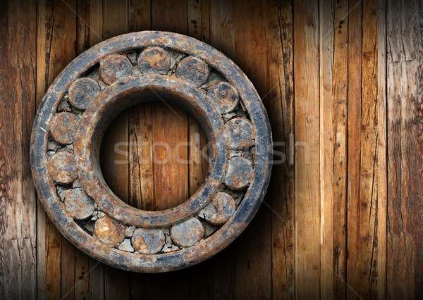 Stock photo: huge rusty ball bearing hung on the wall