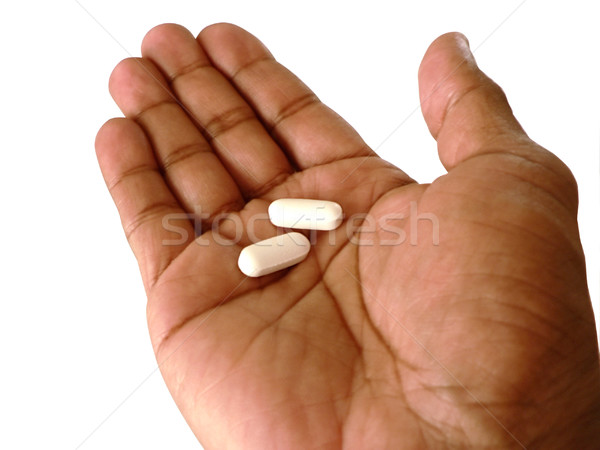 Aspirine Open hand twee pijn geïsoleerd Stockfoto © tdoes