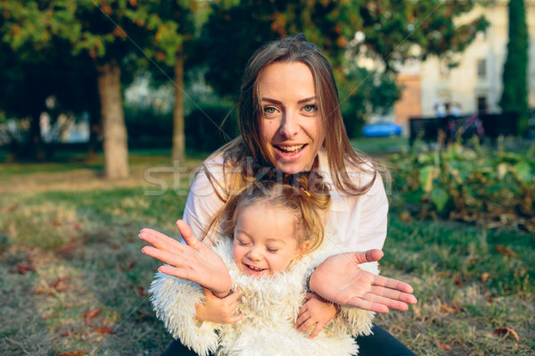 Stock photo: Mother and little daughter in a park