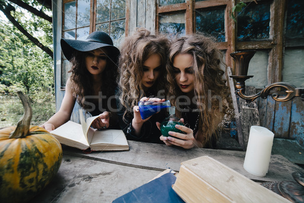 Stock photo: Three vintage witches perform magic ritual