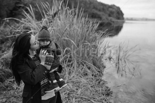 Stock photo: woman and child on the bank of river