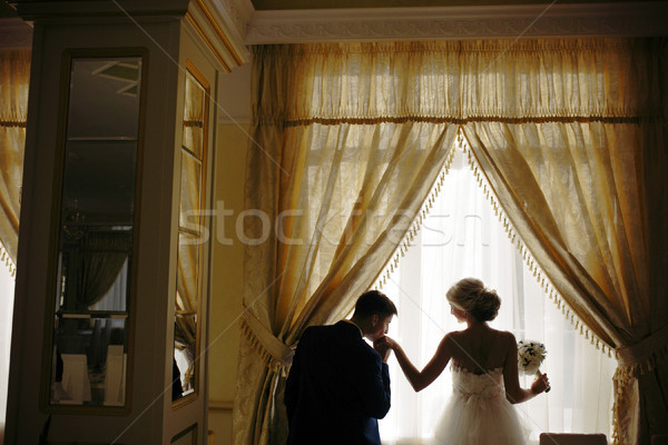 bride and groom standing in front of window Stock photo © tekso