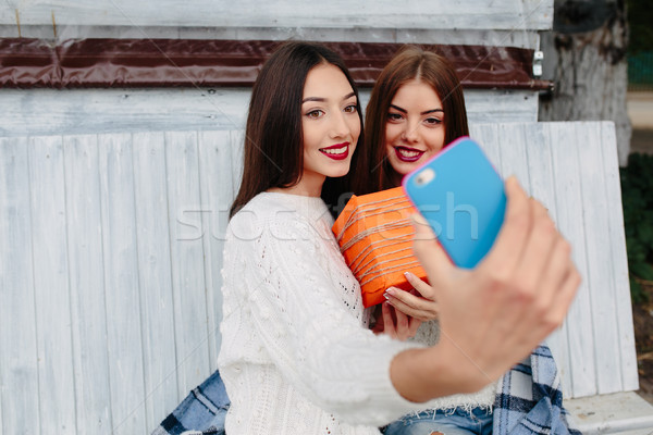 Two girls make selfie with gift Stock photo © tekso