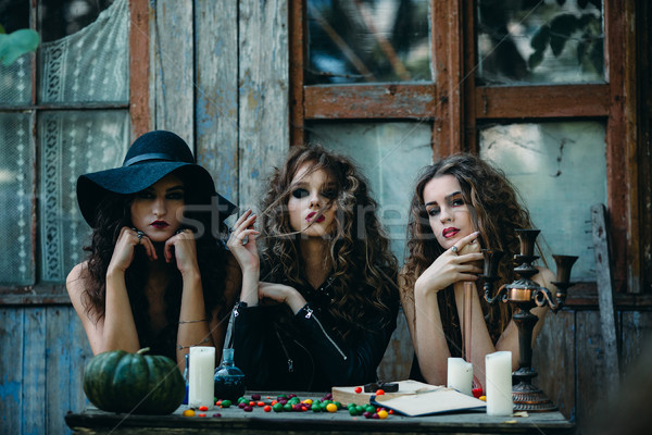 Stock photo: three witches at the table