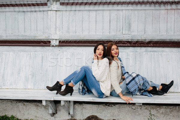 Two girls sit on a bench in the park Stock photo © tekso