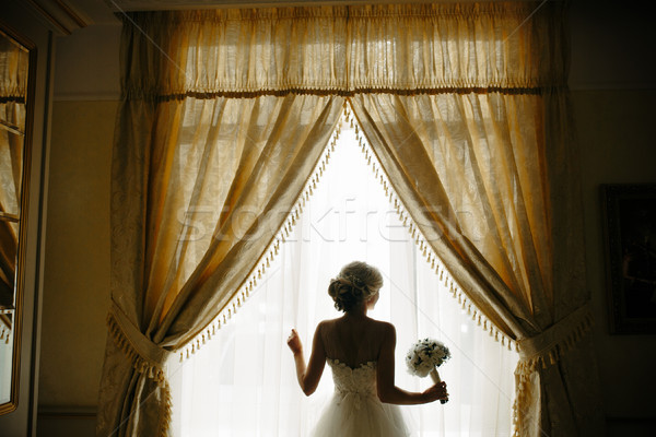 beautiful bride in a wedding dress, by window. Stock photo © tekso