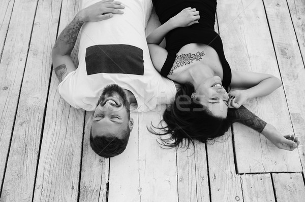 man and woman lie on the wooden floor Stock photo © tekso