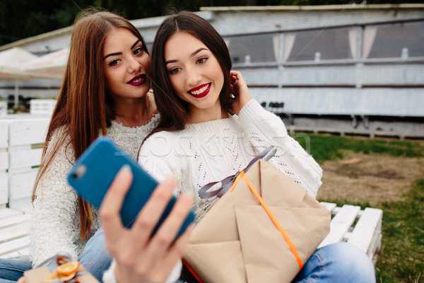 Two girls make selfie with gifts Stock photo © tekso