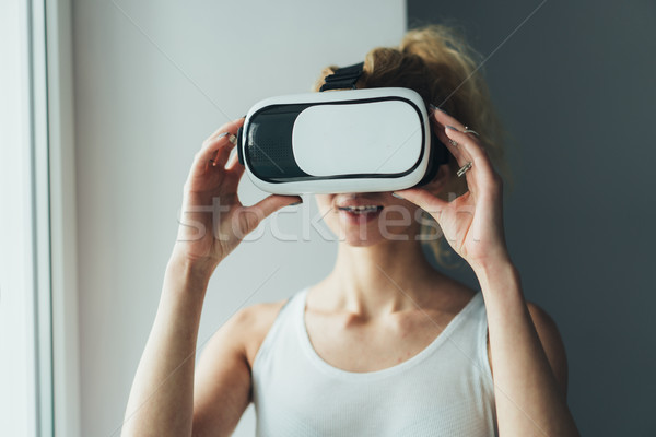 Woman in VR headset looking up Stock photo © tekso