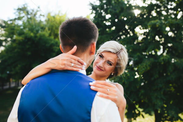 Stock photo: Beautiful wedding couple hugging in the park