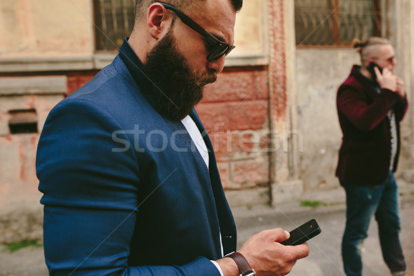 Сток-фото: бородатый · бизнесмен · глядя · телефон · два · бизнесменов
