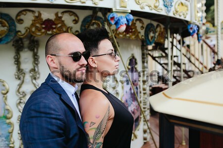 Stock photo: adult man and woman on a carousel