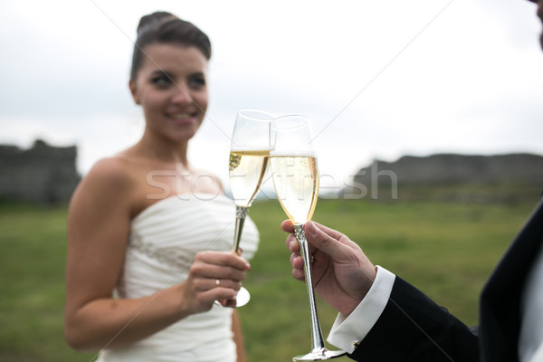 bridal couple clink glasses of champagne Stock photo © tekso