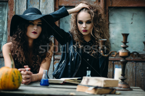 Two vintage witch sitting at the table Stock photo © tekso