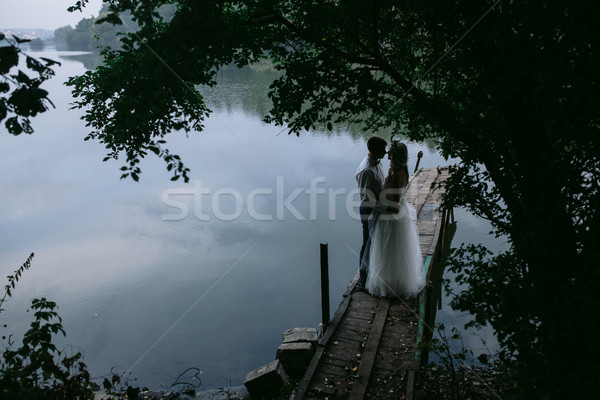 Wedding couple on the old wooden pier Stock photo © tekso