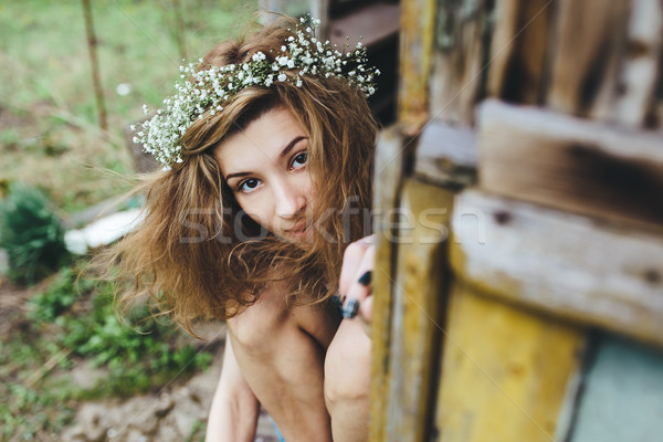 Belle fille espionnage quelqu'un luxuriante jardin printemps [[stock_photo]] © tekso