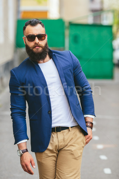 Stylish bearded man walks through the city Stock photo © tekso