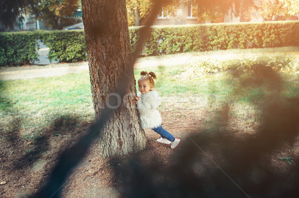 Cute little girl is playing outdoors Stock photo © tekso