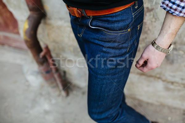 Férfi farmer közelkép lövés pózol fal Stock fotó © tekso