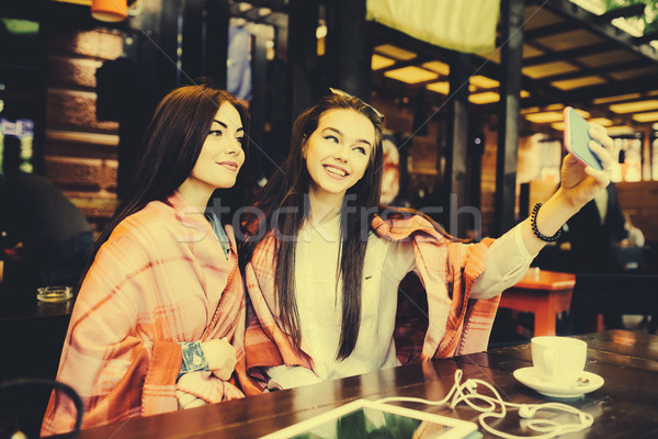 Stock photo: two close friends make selfie in the cafe