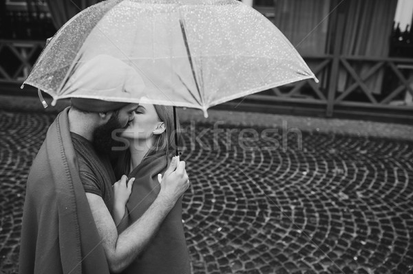 Stock photo: guy and girl under an umbrella