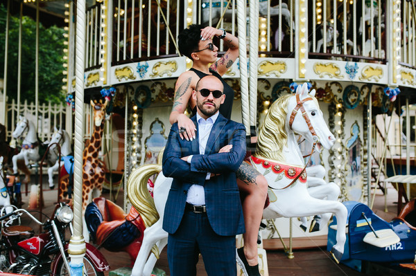 Stock photo: adult man and woman on a carousel