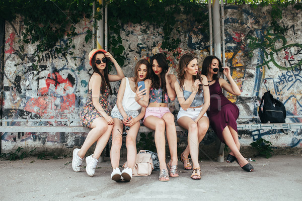 Five beautiful young girls relaxing Stock photo © tekso