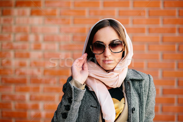 girl posing on a background of red brick wall Stock photo © tekso