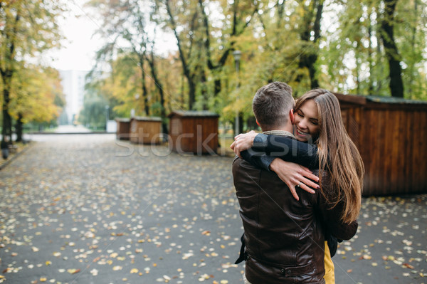 attractive happy couple walking in autumn park Stock photo © tekso