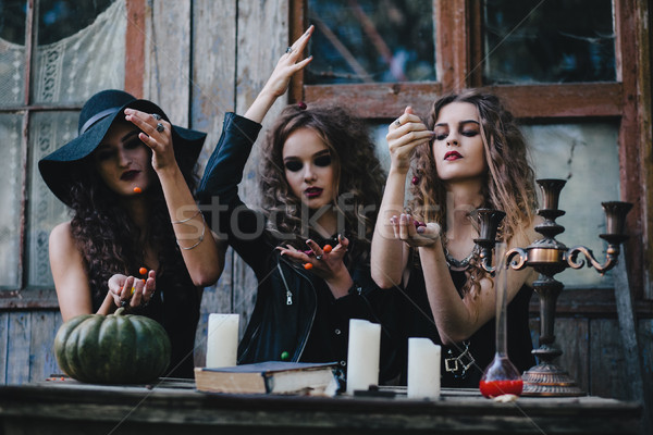 Three vintage witches perform magic ritual Stock photo © tekso