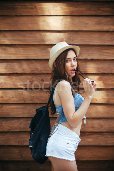 Beautiful girl câmera cidade óculos de sol posando marrom Foto stock © tekso