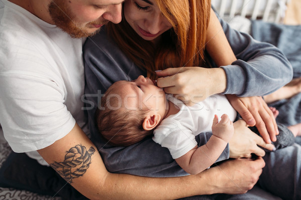 Happy family with newborn baby on the bed Stock photo © tekso