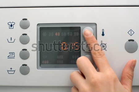 Stock photo: Adjusting a washing machine