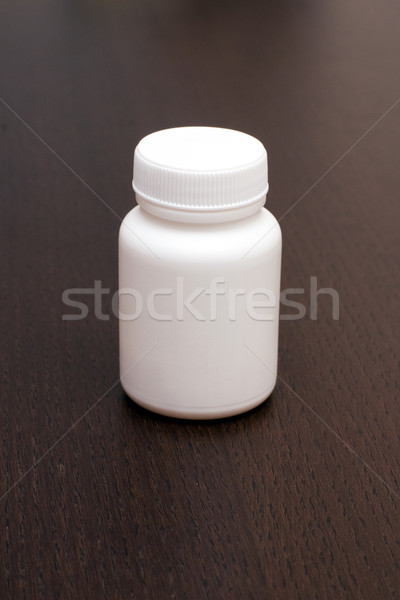 Hapları küçük şişe beyaz konteyner kahverengi arka plan Stok fotoğraf © timbrk
