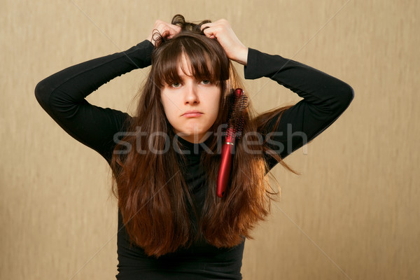 Hairbrush stucks in female hair Stock photo © timbrk