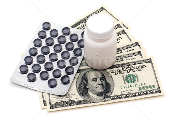 Prijs gezondheid pillen fiool geld geïsoleerd Stockfoto © timbrk