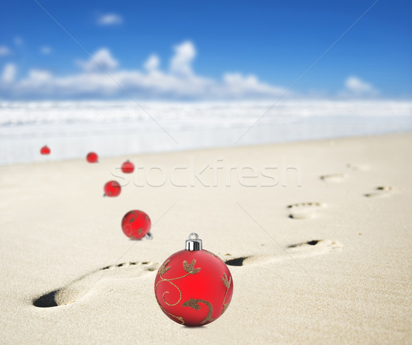 Christmas baubles on a beach with footprints Stock photo © tish1