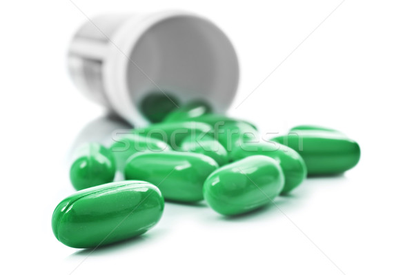 Verde pastile pilulă sticlă alb fericit Imagine de stoc © tish1