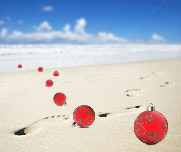 Christmas baubles on a beach with footprints Stock photo © tish1