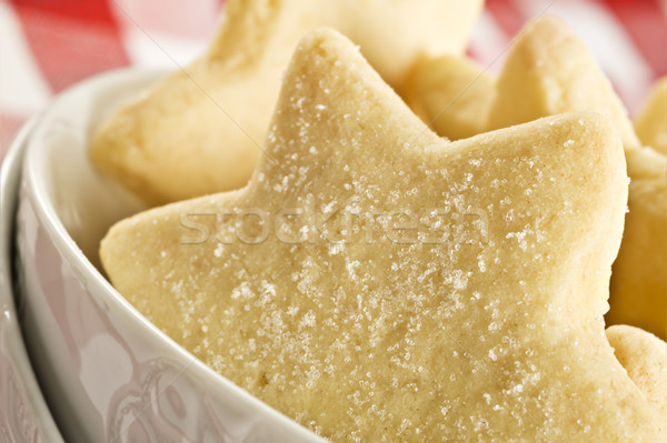 Sugar coated shortbread cookies in star shapes stacked up - on a white background with space for tex Stock photo © tish1