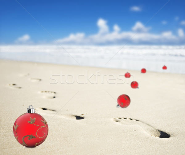 Christmas baubles on a beach with footprints Stock photo © tish1