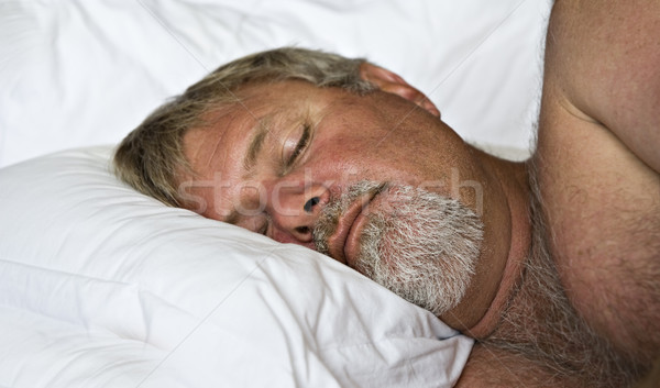 Idős férfi alszik ágy alacsony fény Stock fotó © tish1