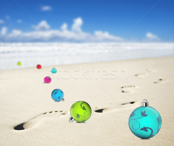 Christmas baubles on a beach with footprints Stock photo © tish1