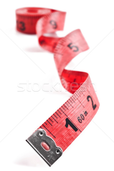Stock photo: Red tape meassure on rolled up on white background