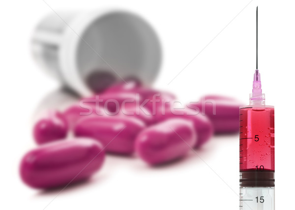 Pink pills an pill bottle on white background Stock photo © tish1